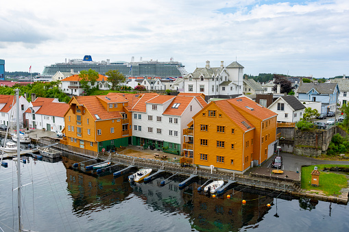 Haugesund Harbour and harbour side buildings, Norway.  There is a cruise ship docked in the background.