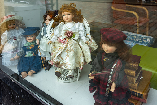 Haugesund Harbour and harbour side buildings, Norway.  This is a giftshop window with old fashioned dolls in the window.
