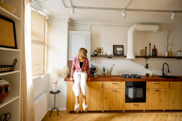 istock Modern kitchen interior with person sitting on table top 1424661654