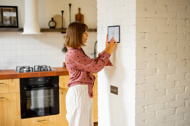 istock Woman use a digital tablet to control temperature in apartment 1424661821