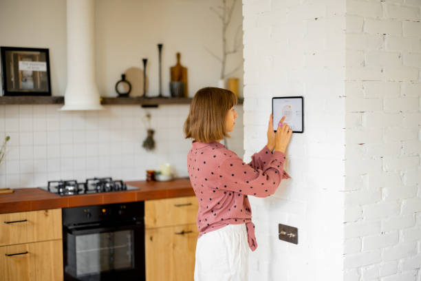 istock Woman use a digital tablet to control temperature in apartment 1424661866