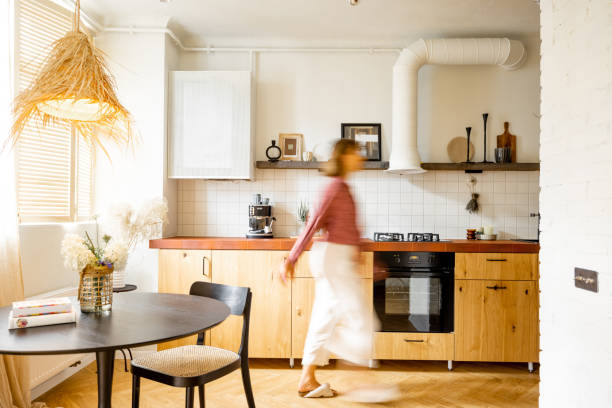 istock Modern kitchen interior with female person 1424662685