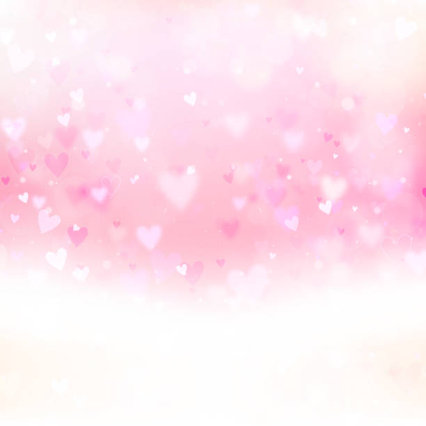 istock Valentines Day background with hearts and bokeh lights. Pink love background with hearts and sparkle lights. 1424663504