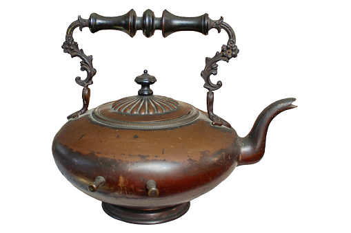 vintage copper teapot with a twisted handle on a white background, isolate