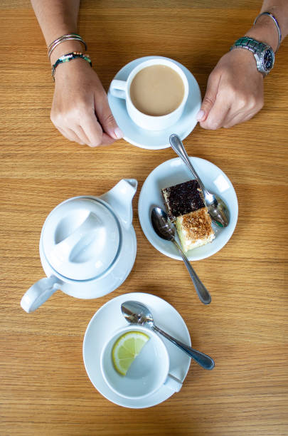 istock woman sitting at breakfast with coffee and cake 1424664322
