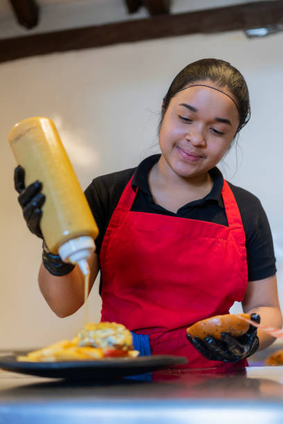 istock A restaurant employee prepares sauce in a jar 1424665342