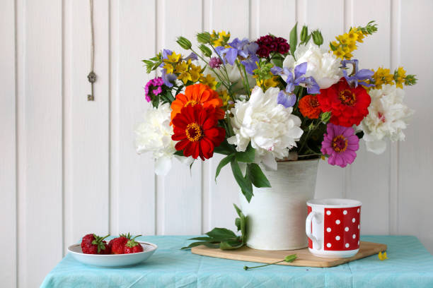 istock Summer still life with flowers and berries on the table. 1424666004