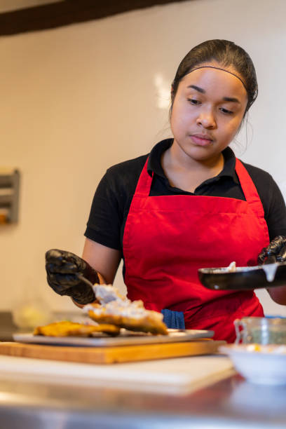istock A restaurant employee prepares sauce in a jar 1424666115