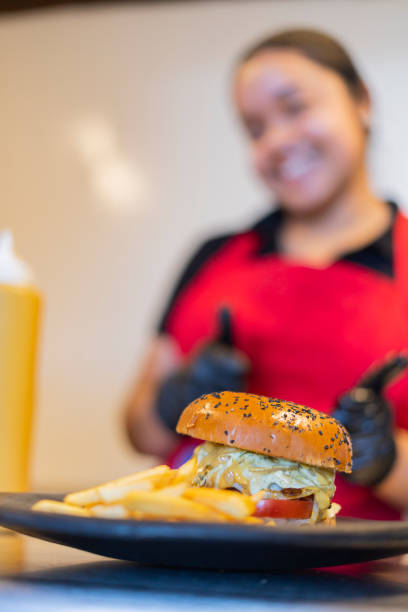 istock A restaurant employee prepares sauce in a jar 1424666389