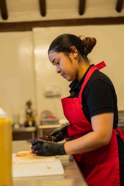 istock A restaurant employee prepares sauce in a jar 1424666465