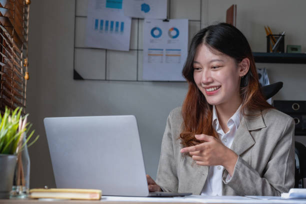 istock Businesswoman presenting profit data with graphs to her supervisor via laptop computer. 1424667499