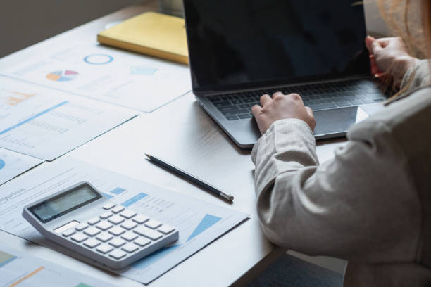 istock Businesswoman presenting profit data with graphs to her supervisor via laptop computer. 1424668326