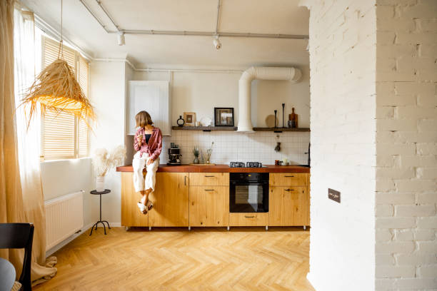 istock Modern kitchen interior with person sitting on table top 1424668501