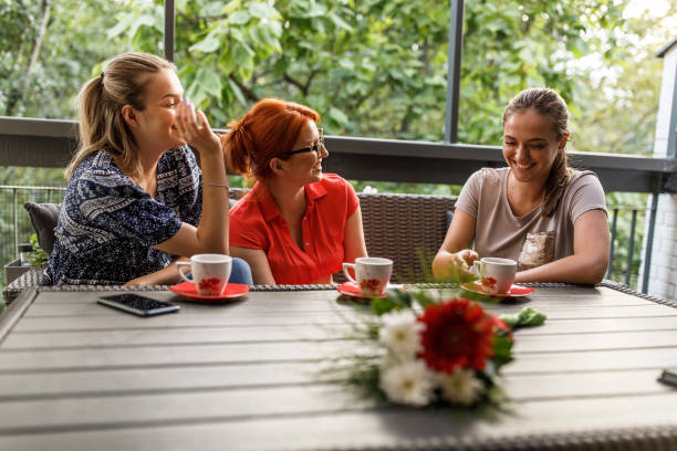istock Mother and her daughters bonding and laughing over coffee 1424670183