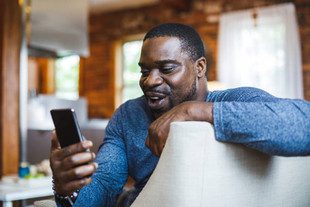 istock Joyful man having fun while video chatting with a friend 1424671141