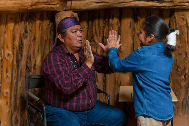 Indigenous navajo Father and son joking around - candid fun moment