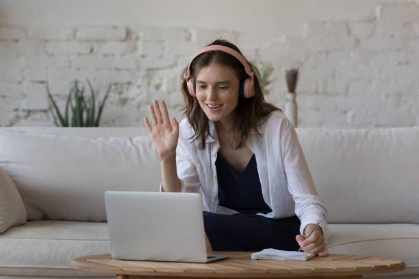 istock Woman makes videocall, greets tutor, start online class at home 1424679364