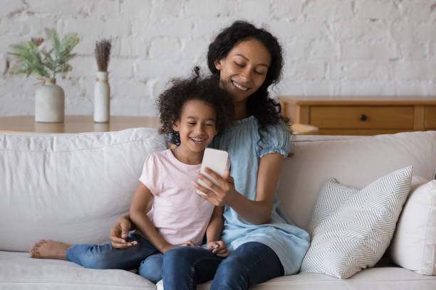 istock African girl her mum make videocall use app on smartphone 1424679624