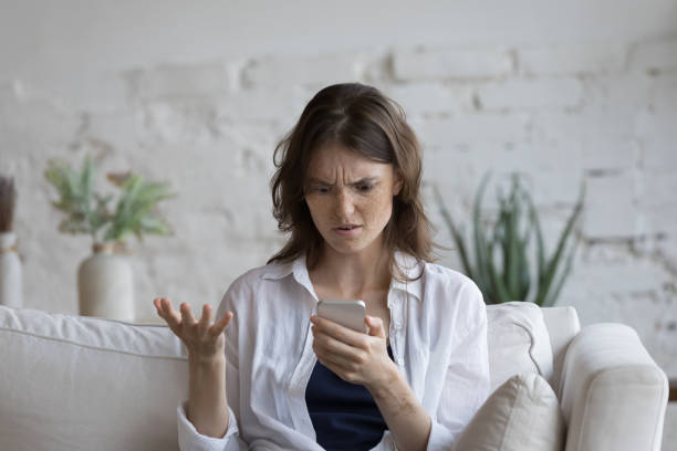 istock Young woman feels annoyed having problems with broken smartphone 1424679944