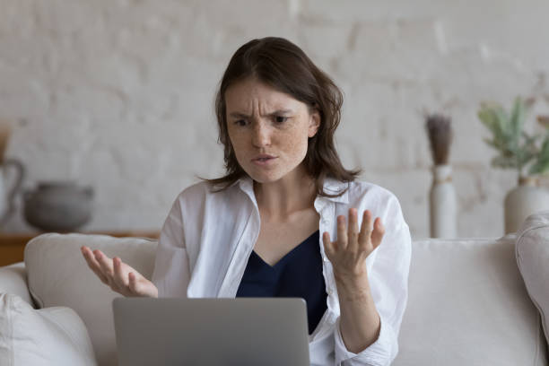 istock Woman staring at laptop feels angry due to broken device 1424679954