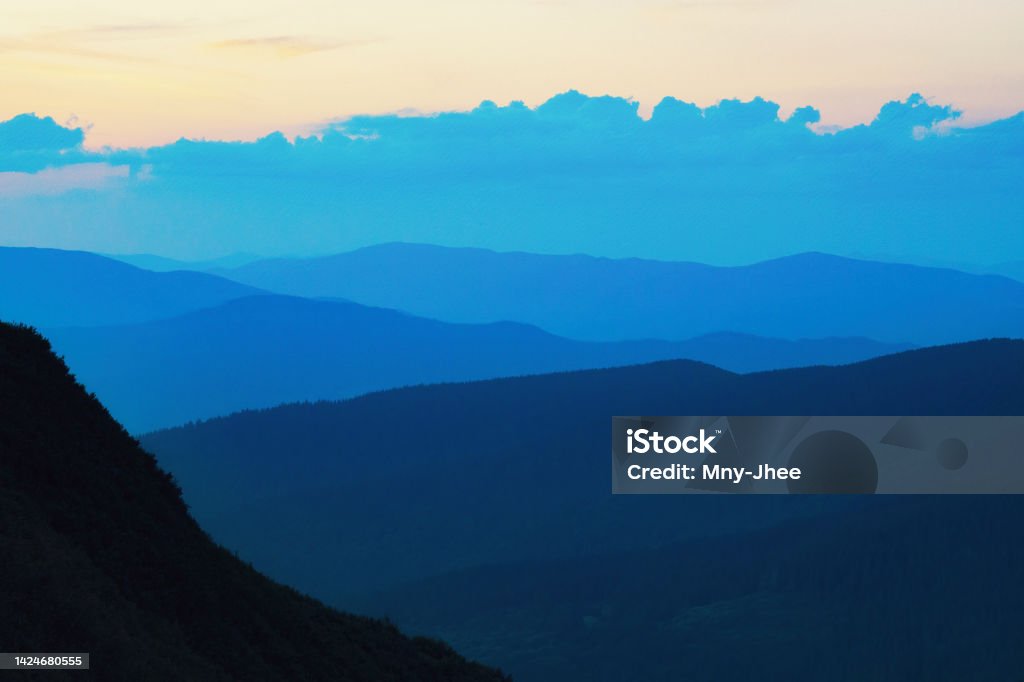 Blue mountain silhouettes. Blue mountain silhouettes. Artistic photo of the sunset mountains with tonal perspective Landscape - Scenery Stock Photo