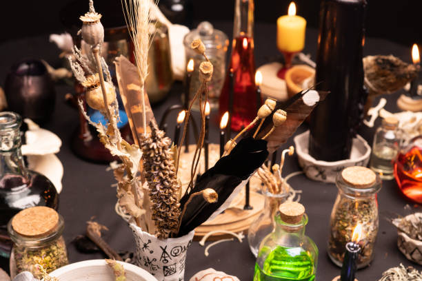 istock Witchcraft still life with witch weeds selective focus at front. Esoteric gothic and occult witch table for Halloween. Various magic objects and ritual arrangement with symbols. Gothic Halloween. 1424685531