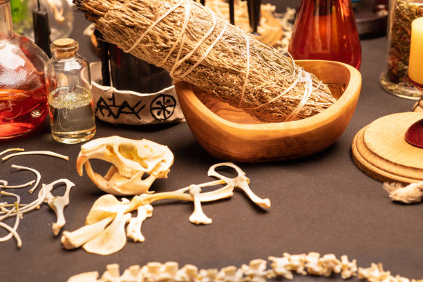 istock Witchcraft table set, selective focus. Alchemy and esoteric symbol items for magic cult. Spiritual occultism and magic chemistry inspired by mysticism. Witch and warlock magician concept. Halloween. 1424685560