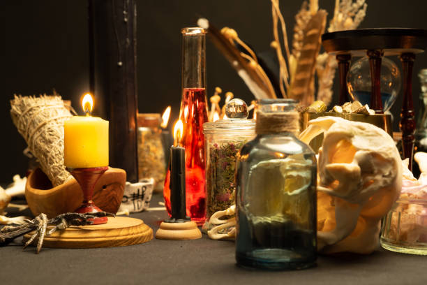 istock Witchcraft table set, selective focus. Alchemy and esoteric symbol items for magic cult. Spiritual occultism and magic chemistry inspired by mysticism. Witch and warlock magician concept. Halloween. 1424685625
