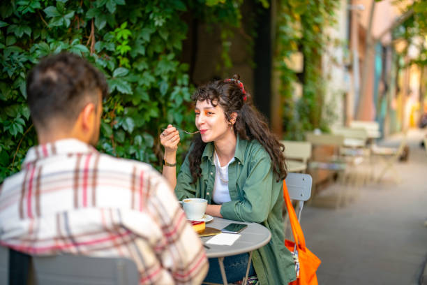 istock Young couple at the sidewalk cafe bakery 1424691150