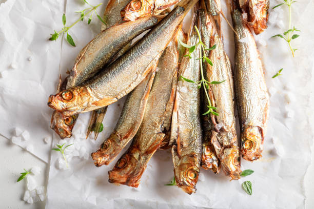 istock Fresh smoked sprats on white food paper. 1424696915