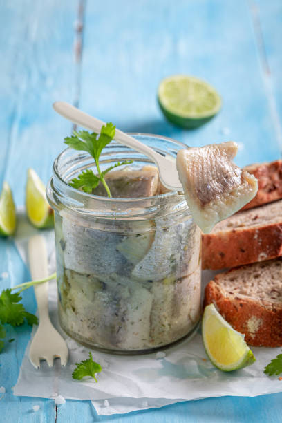 istock Delicious and fresh marinated herring in jar with oil. 1424697611