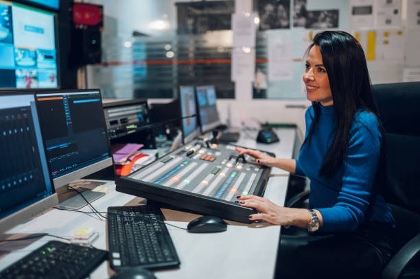 istock Middle aged woman using equipment in control room on a tv station 1424700700