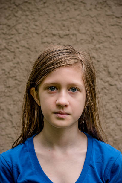 A portrait of a teen girl on a brown background