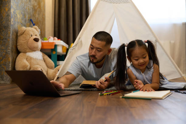 istock Father works from home and babysits little daughter 1424705637