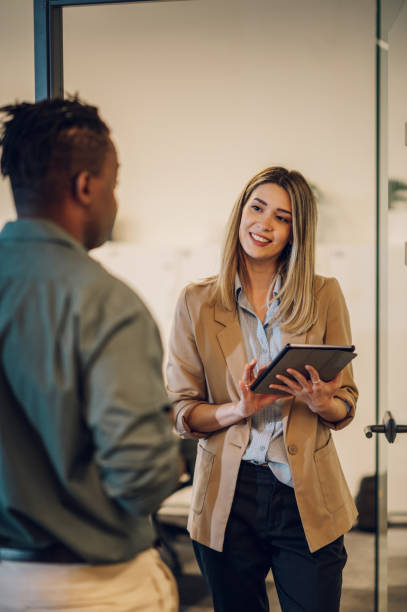 istock Two multiracial business colleagues working together on a digital tablet 1424705835