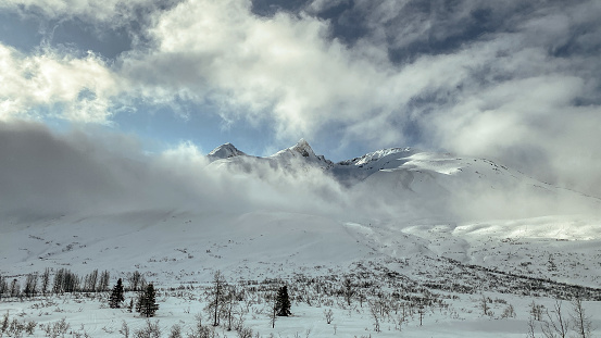 Travelers who pass through Thompson Pass, on their way to Valdez, Alaska will climb to the top it the mountains. At times theses mountains will peak through the clouds, giving just a glimpse of their majesty.