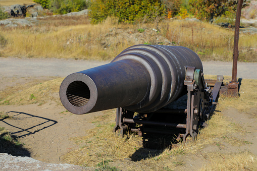 Single historic cannon protecting the harbor of Helsinki on the island fort of Soumenlinna
