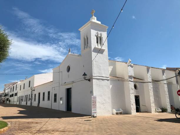 Traditional white color of the facade of the building. Detail of the small church with a cross on the top. Masdache, Lanzarote, Canary Islands, Spain.