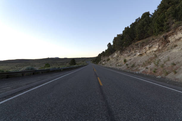 istock Empty Two-Lane Road In Rural Landscape Blue Sky 1424729686