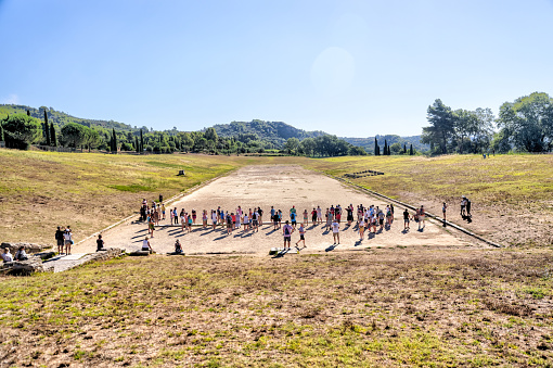 Olympia, Greece - July 19, 2022: Visitors taking in the landscapes and ancient relics at the site of the original olympics at Olympia, Greece