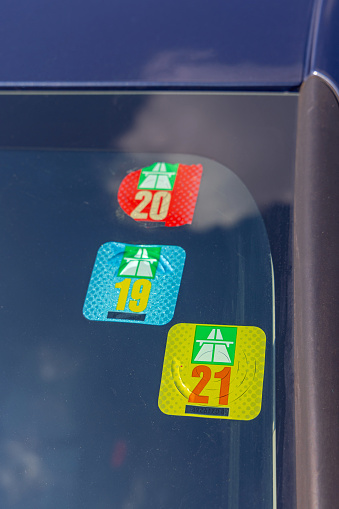Bern, Switzerland - August 25, 2022: Three Swiss Road Tax Stickers Vignette at Car Windshield.