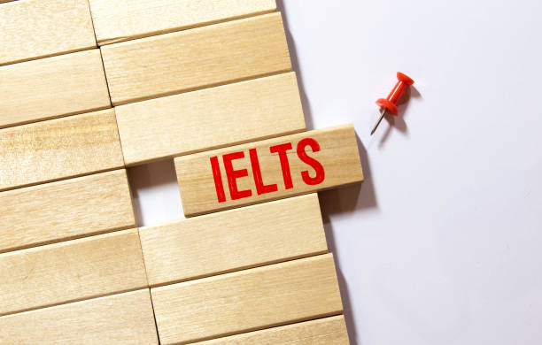 wooden blocks with the text ielts - International English Language Testing System. stock photo