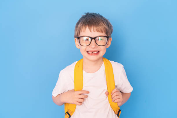 istock A little boy with a yellow briefcase stands in front of a blue background 1424746466
