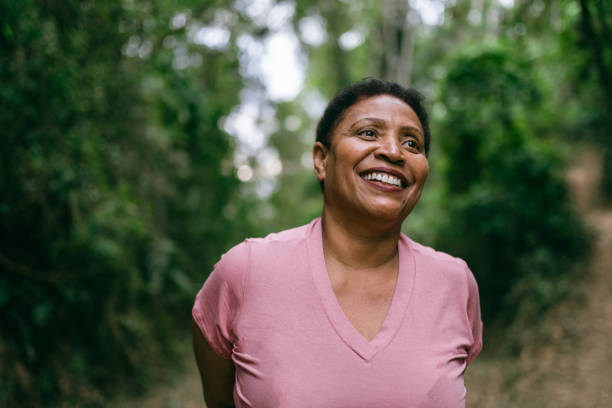 mature woman contemplating nature - candid imagens e fotografias de stock