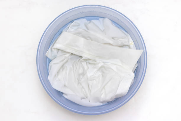 istock White clothes soaked in water in a basin 1424749577