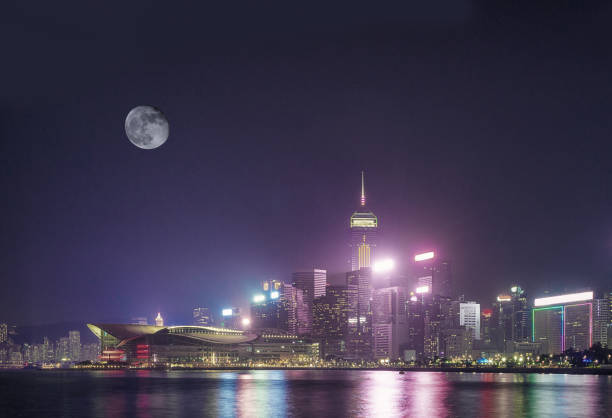 The moon hangs over the Convention and Exhibition Centre in Wanchai, Hong Kong.