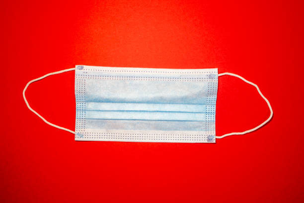 istock Medical mask on a red background 1424762482