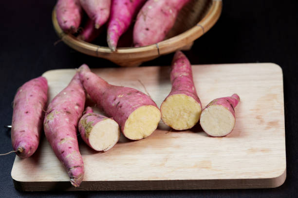 istock Fresh raw sweet potato on cutting board 1424775808