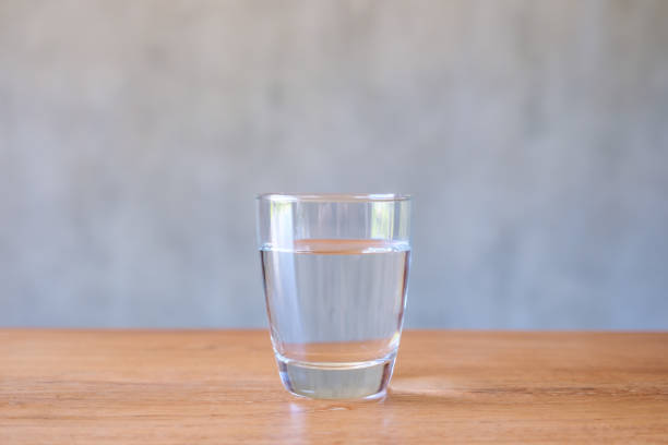 istock A glass of drinking water on wooden table 1424781748