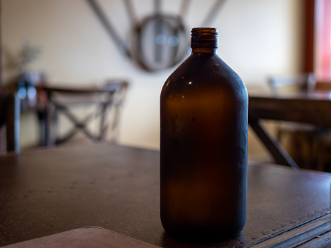 Old dirty and glass bottle with unknown liquid,image of a